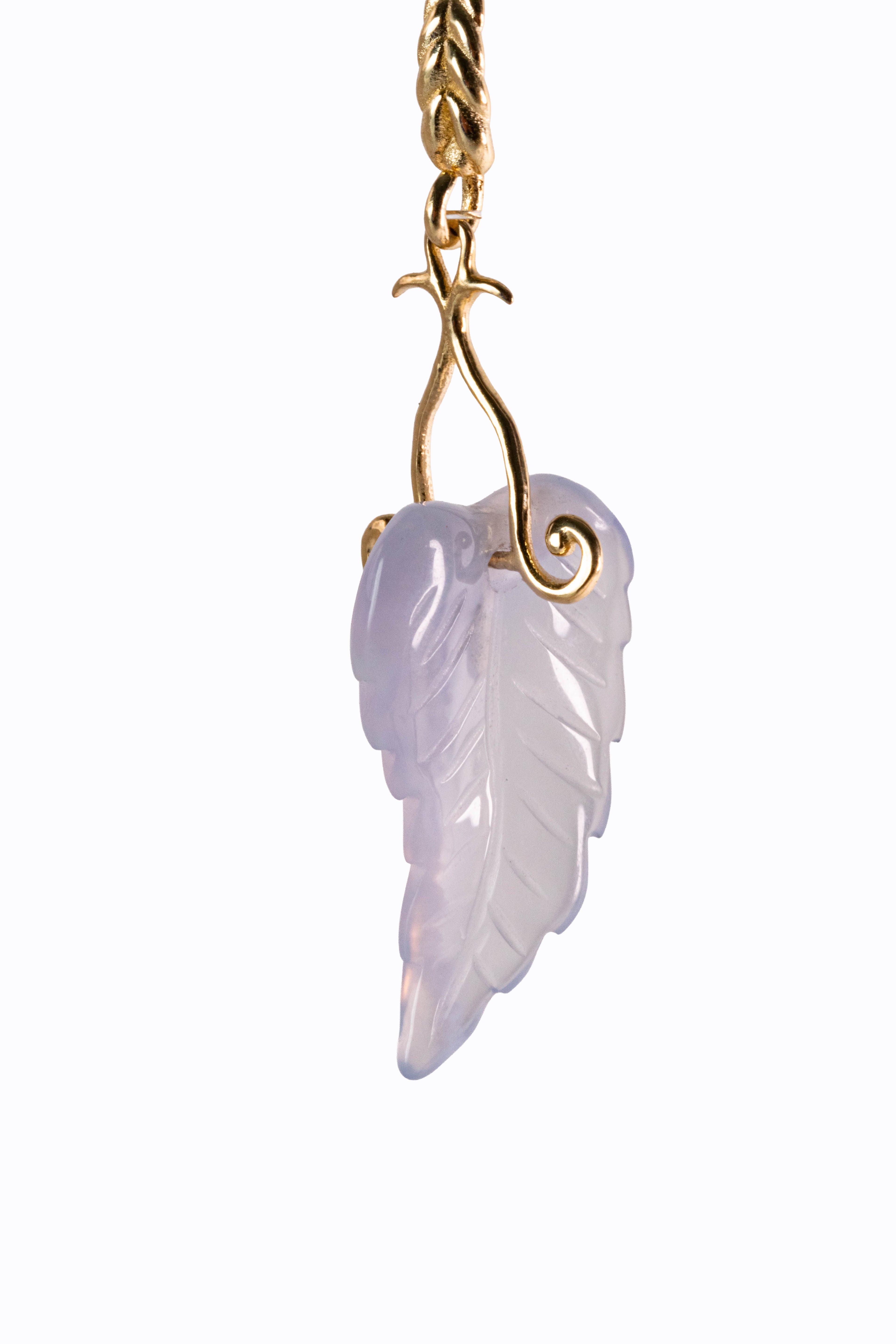 Close-up detail of Havina earring carved lavender chalcedony leaf with 14k gold scrollwork by Alexandra Essex