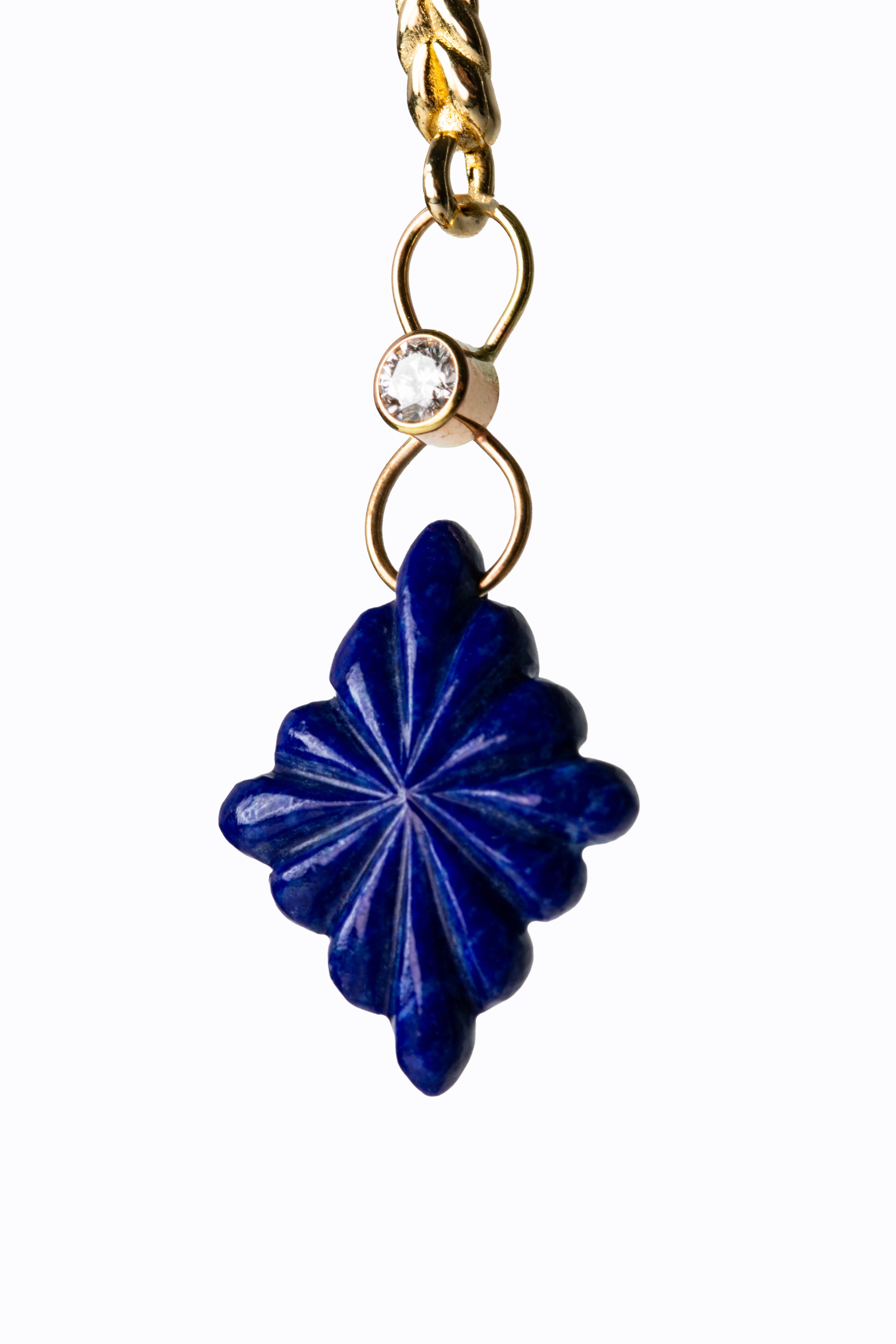 Close-up of Midnight carved lapis lazuli earring showing star carving detail, bezel-set diamond, and 14k gold link by Alexandra Essex