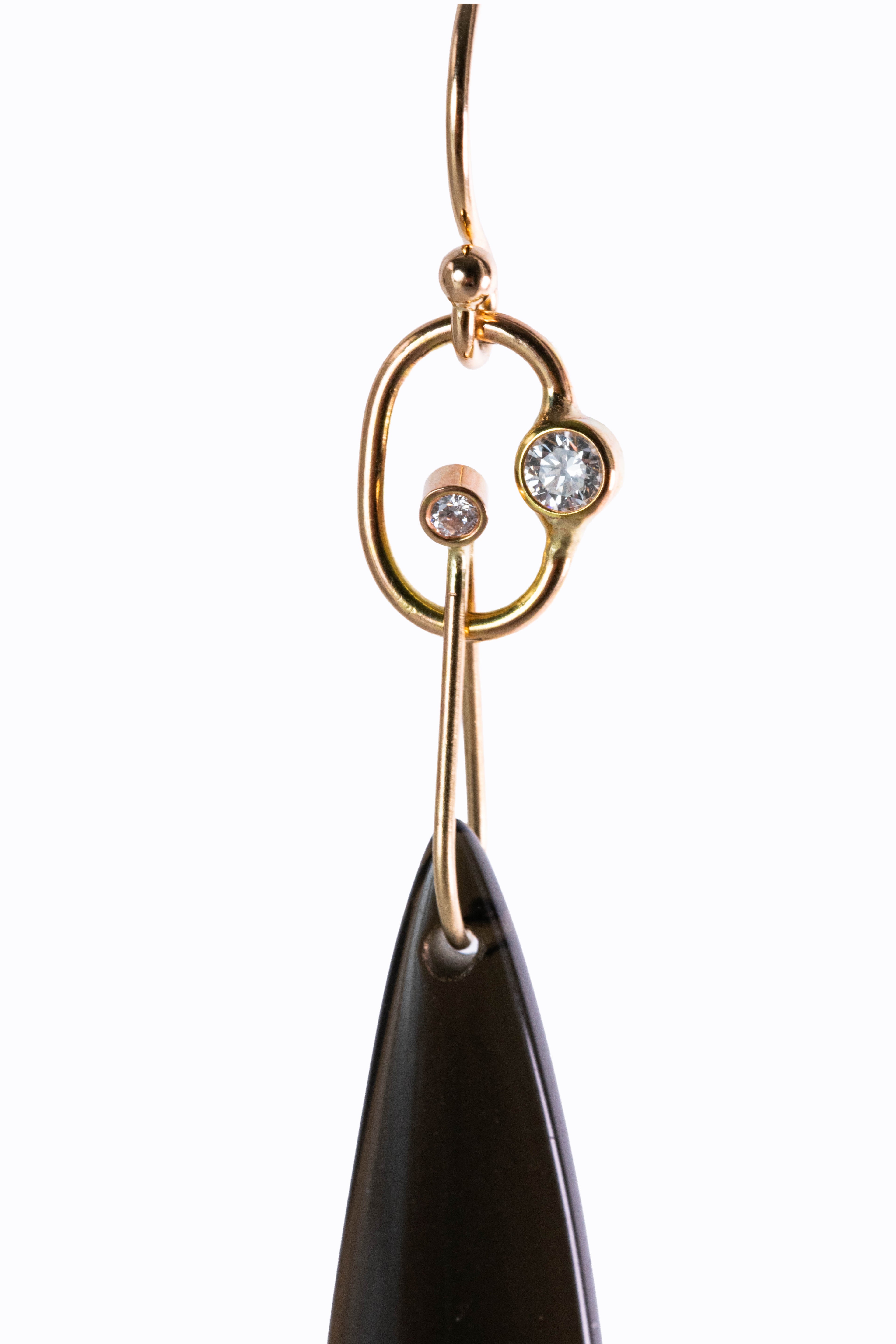 Gatsby earring close-up showing 14k yellow gold decorative French hook with bezel-set diamonds and black obsidian teardrop by Alexandra Essex