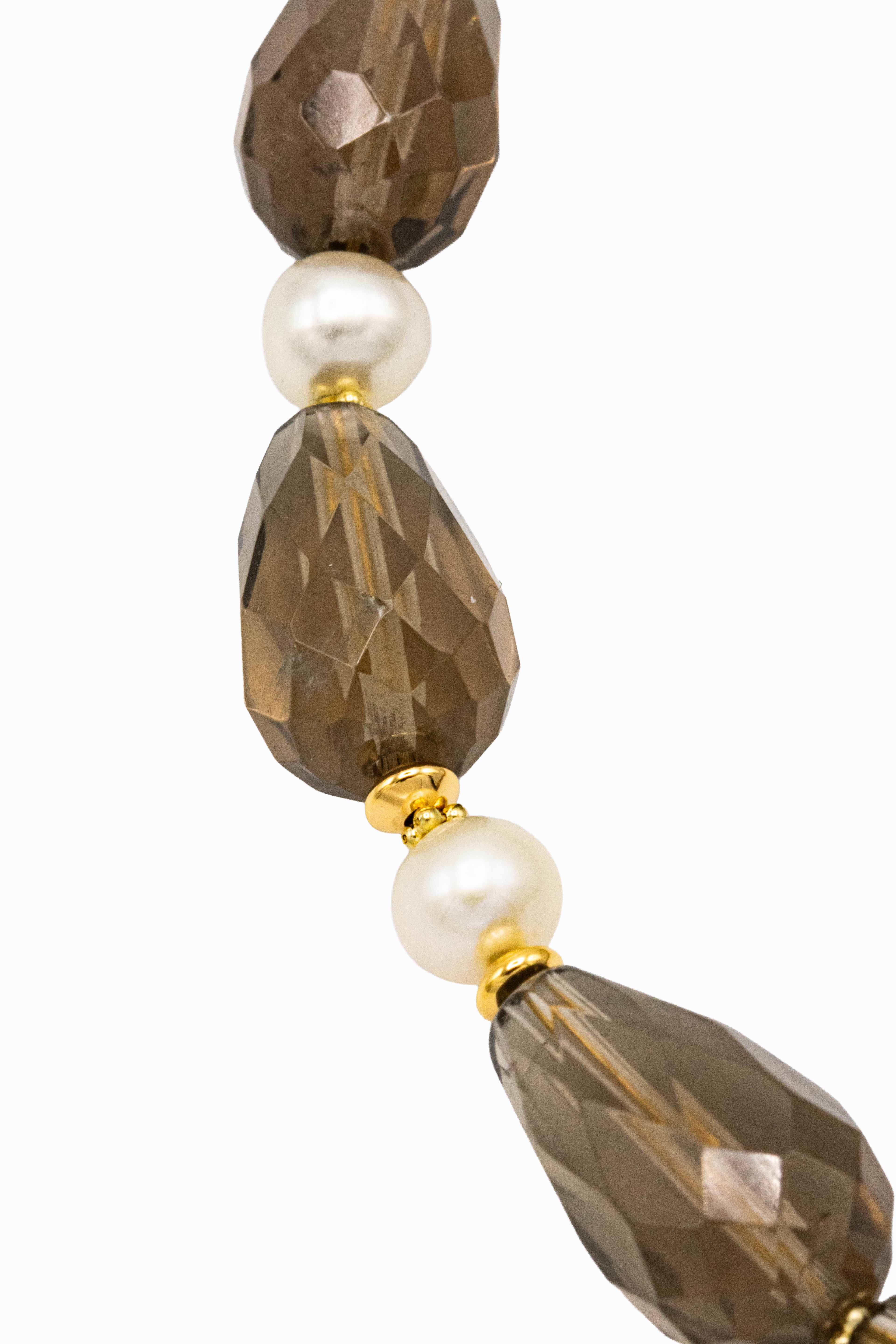Close-up of Gris necklace faceted smoky quartz nuggets with white cultured pearl accents and 14k gold bead detail by Alexandra Essex