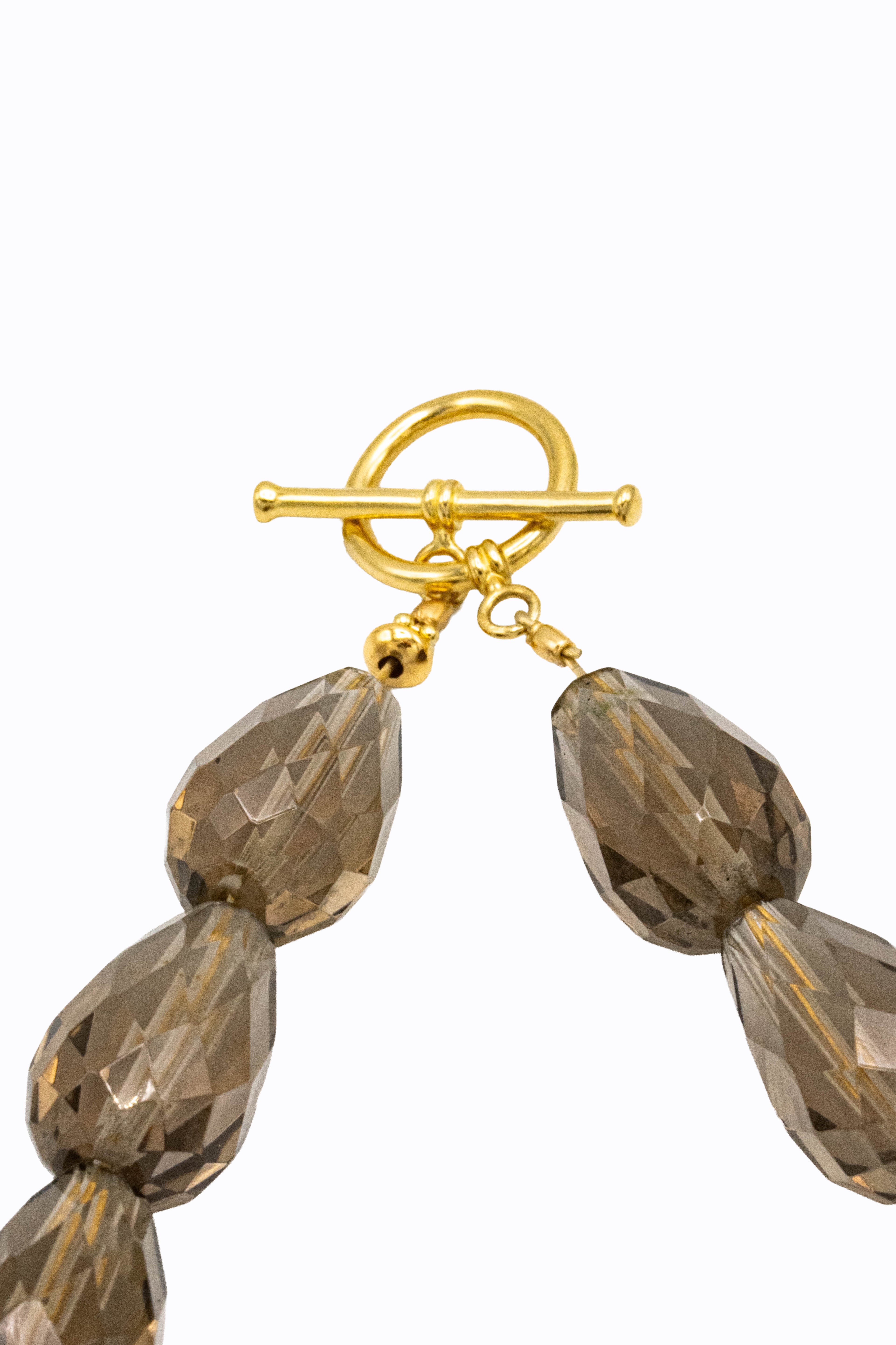 Detail of Gris necklace 14k yellow gold toggle clasp with faceted smoky quartz briolette drops by Alexandra Essex