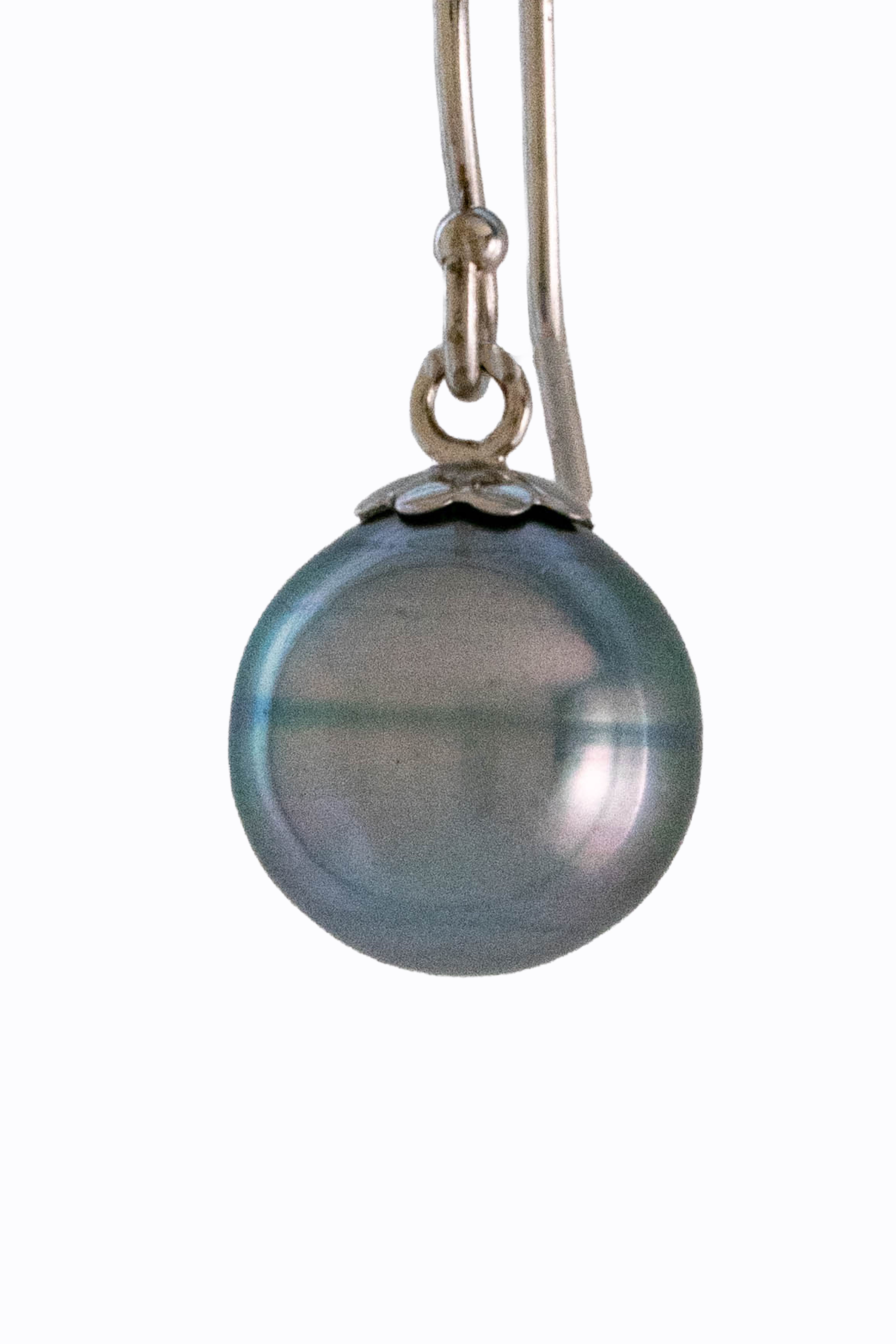 Close-up of Moonrise Tahitian pearl showing silver smoke iridescent surface and 14k white gold hook detail by Alexandra Essex