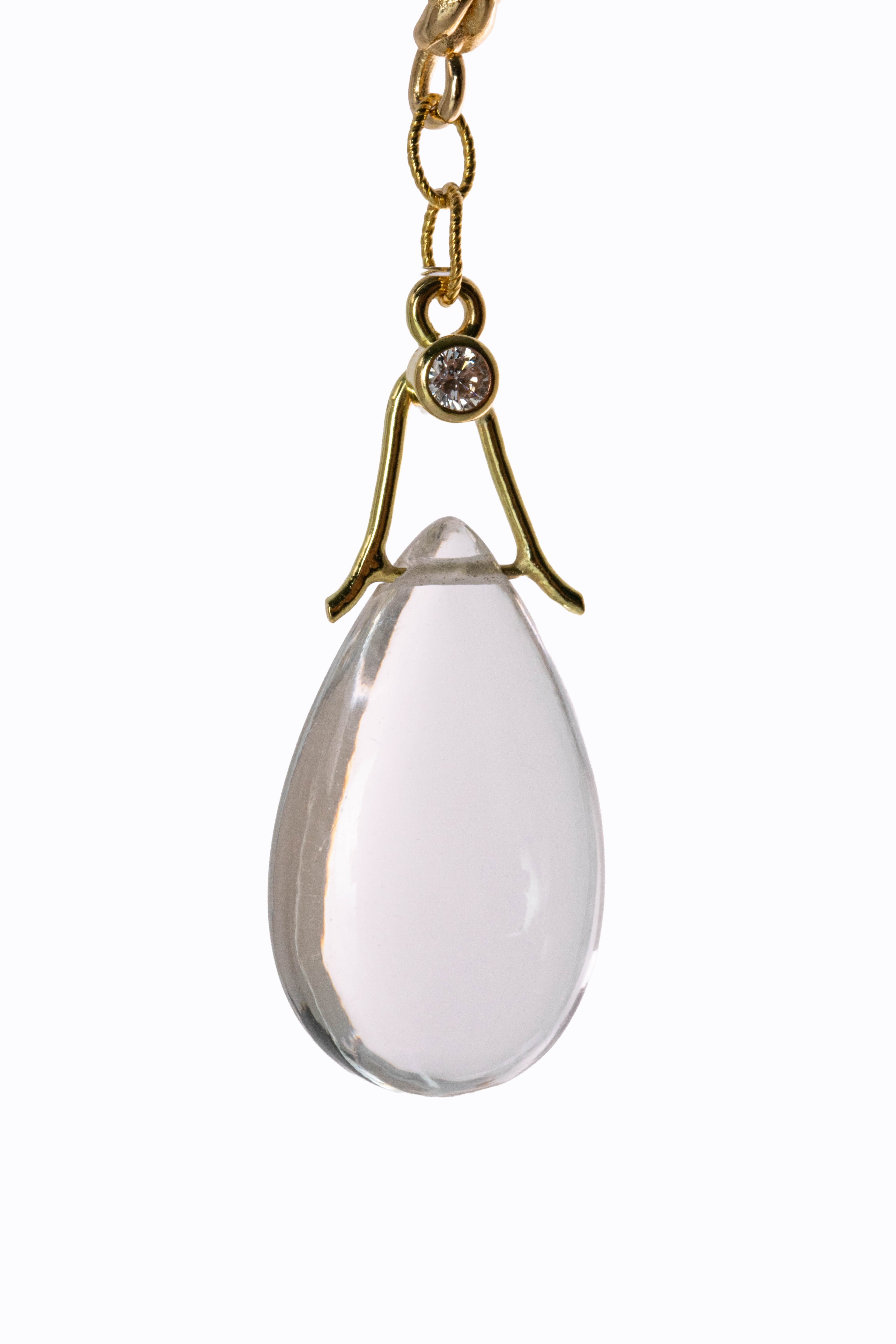 Close-up detail of Clarity earring rock crystal briolette with bezel-set diamond accent in 14k gold by Alexandra Essex