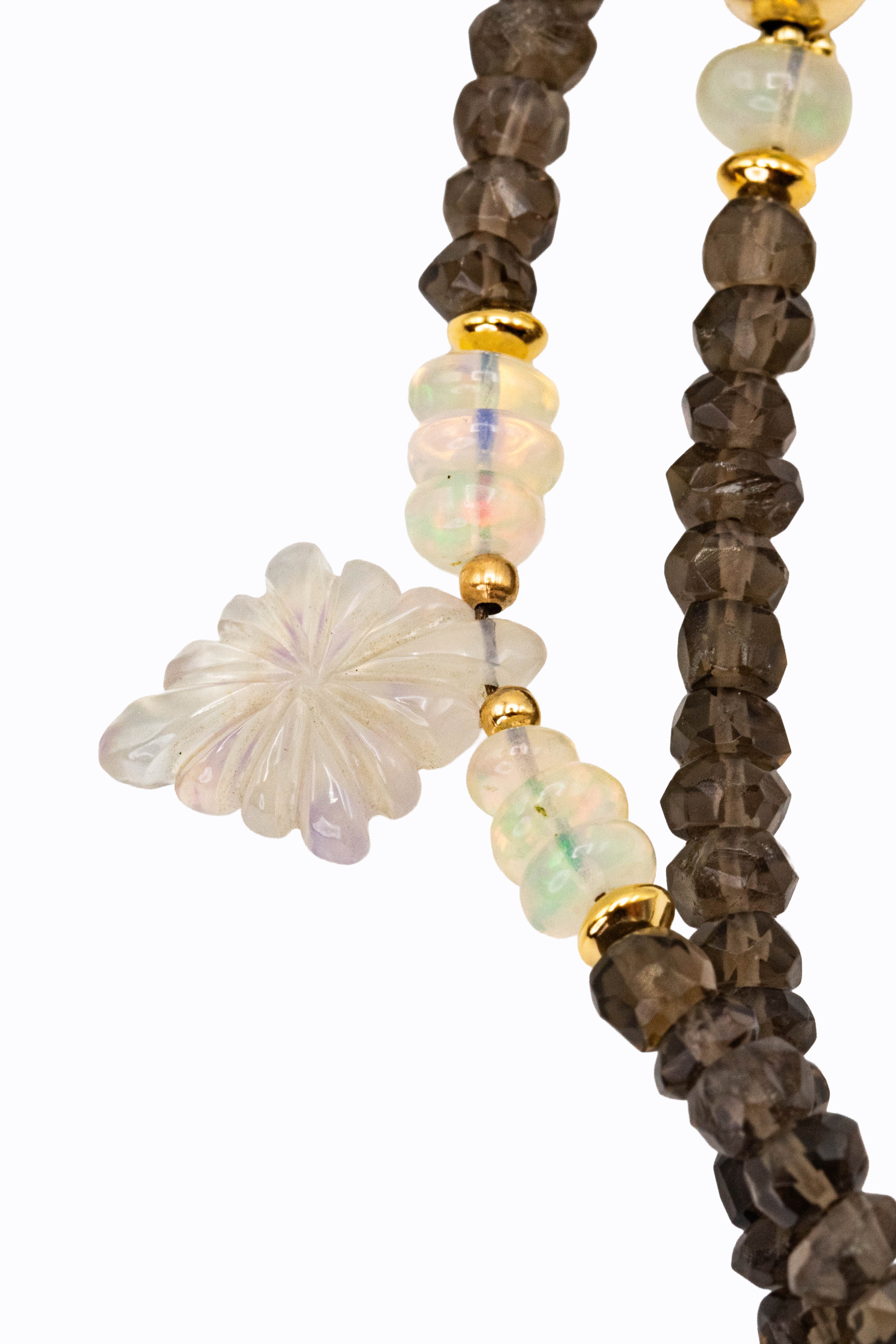 Detail of Sahara necklace showing carved grey moonstone flower bead, Ethiopian opal with green and orange fire, and faceted smoky quartz rondelles on 14k gold by Alexandra Essex