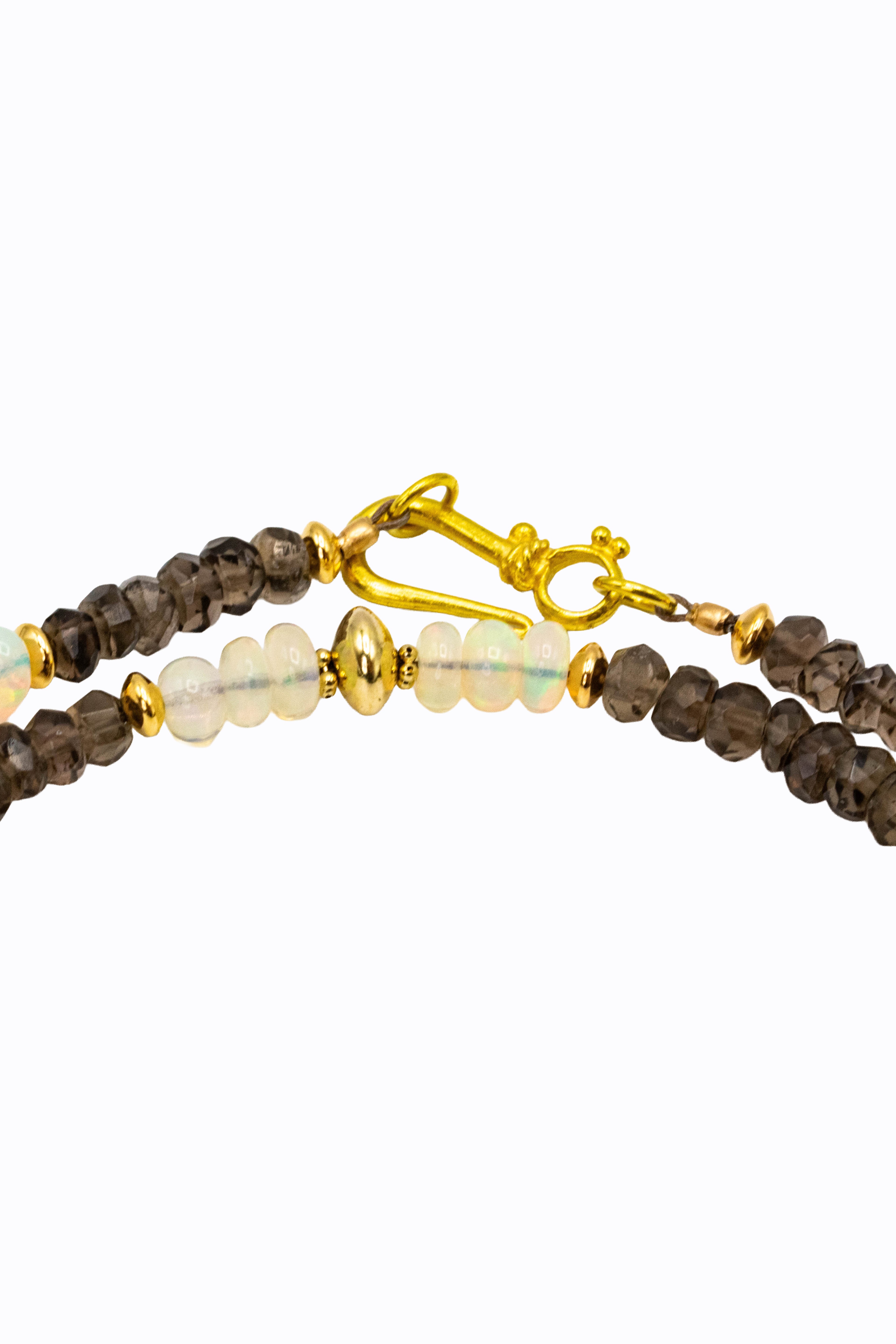 Detail of Sahara necklace 14k yellow gold hook clasp with smoky quartz rondelles and Ethiopian opal bead accents by Alexandra Essex
