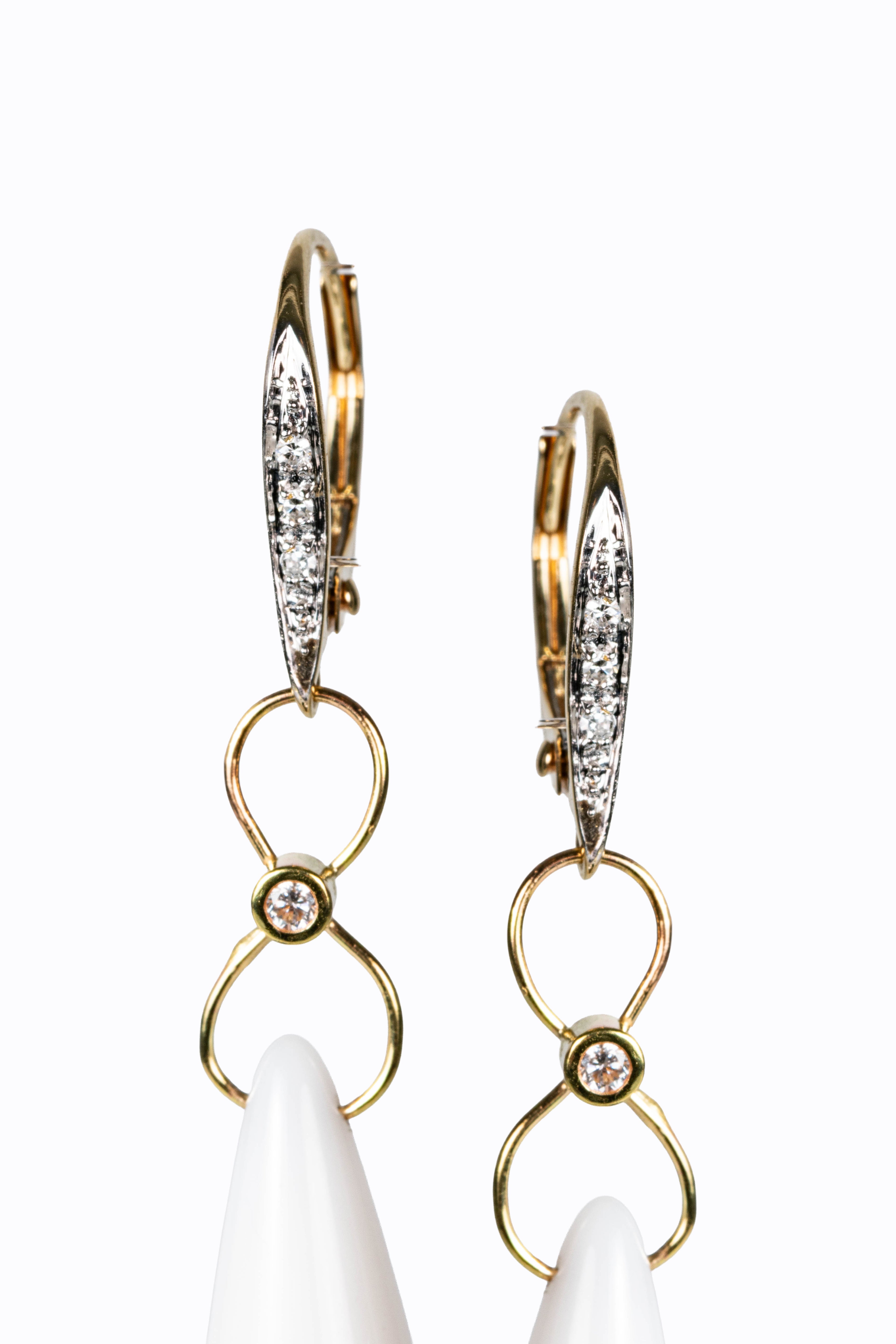 Detail of La Luna 14k gold leverback earrings showing bezel-set diamond accents and white agate briolette drops by Alexandra Essex